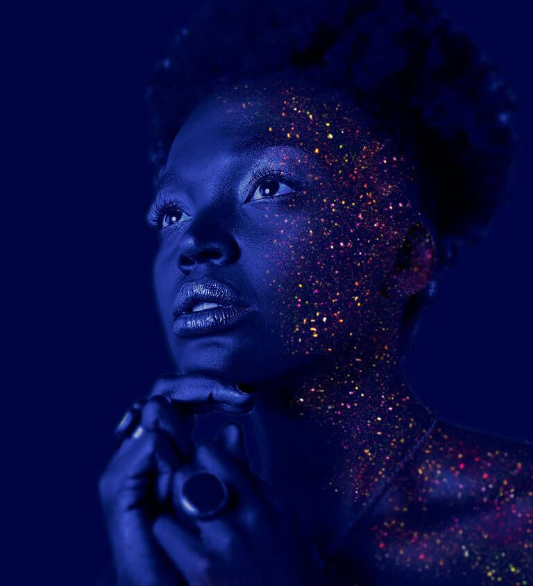 fashion photography of woman hands on chin with glitter makeup